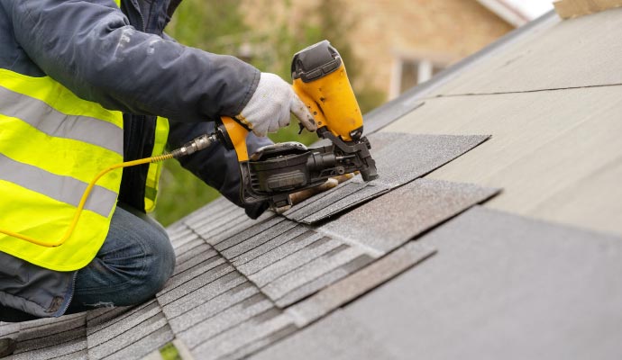 Professional worker repairing roof