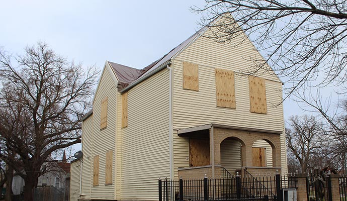 Boarded-up vacant house