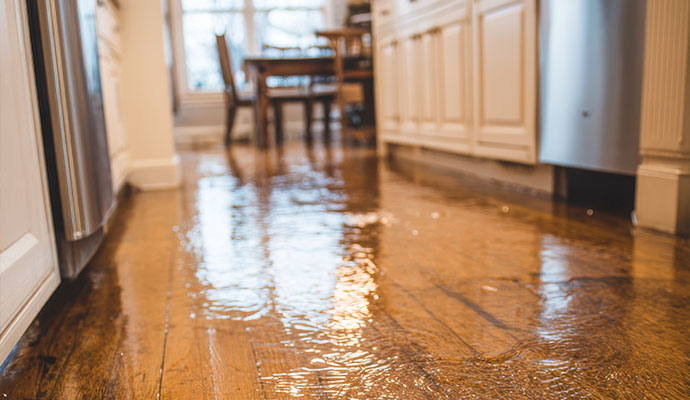 Clean water flooding residential kitchen hardwood floor