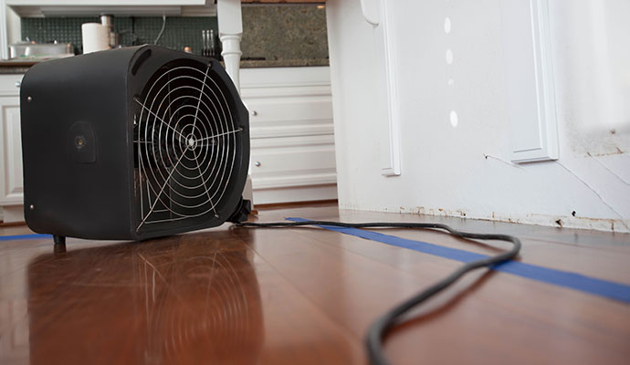 Restoring water damaged hardwood floor using centrifugal air mover