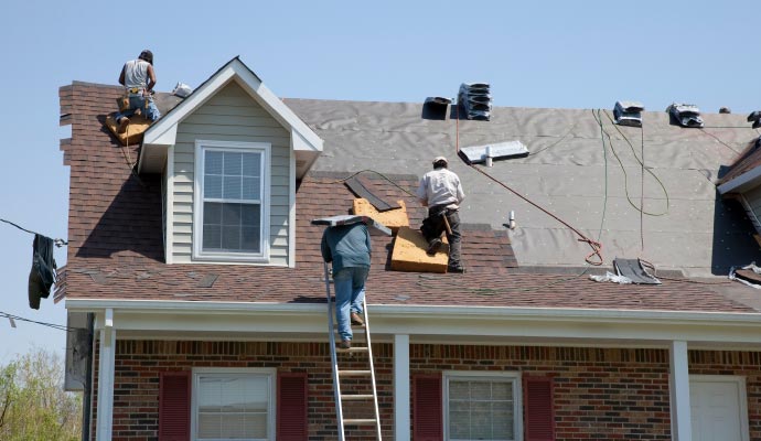 M&J Restoration team repairing roof