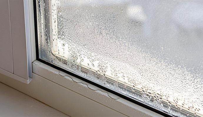 Heavy condensation and moisture buildup on a double-pane glass window