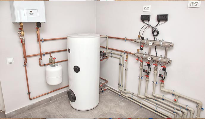 Modern mechanical room with water storage tank, boiler, and organized plumbing system