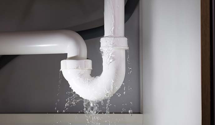 White sink pipe leaking water