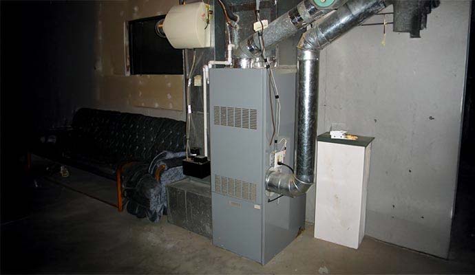 Residential basement furnace unit with metal duct pipes
