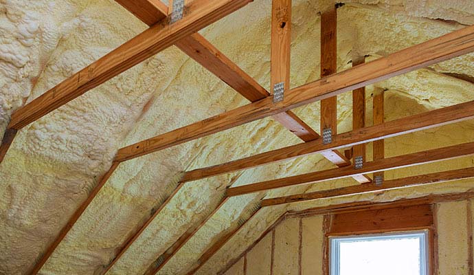 Spray foam insulation coating an attic ceiling