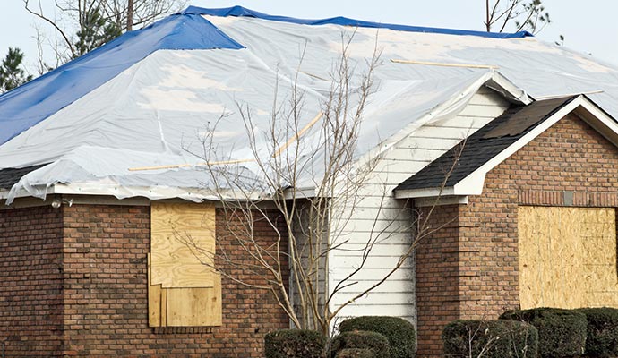 Storm damaged house tarping