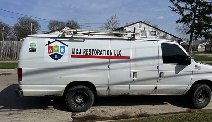 M and J restoration service van