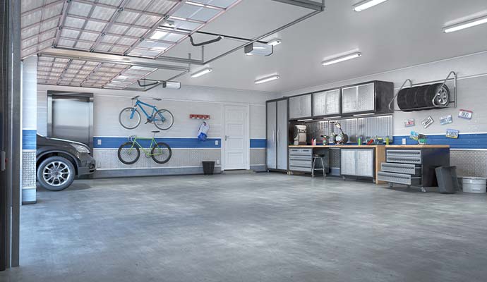 Restored residential garage with clean concrete floor and storage