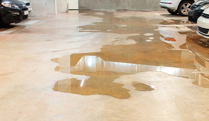 Standing floodwater puddle on concrete garage floor