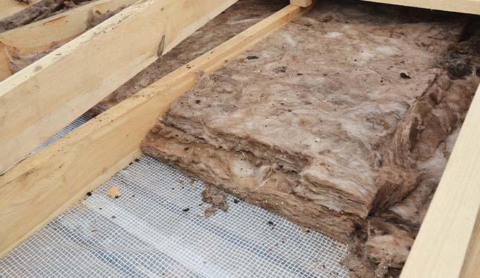 Wet fiberglass insulation between wooden joists
